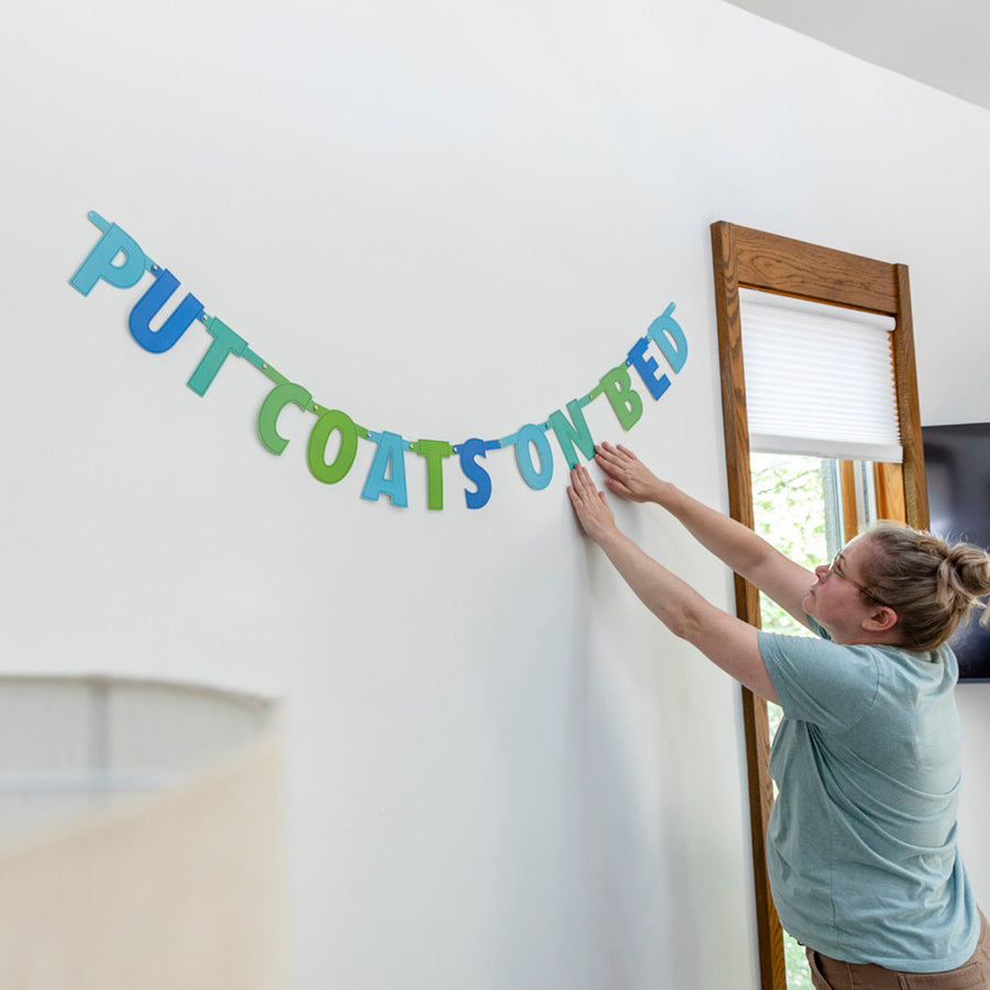 "Put Coats on Bed" hanging banner