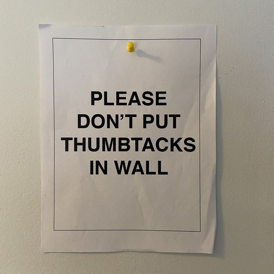 joke thumbtack policy flyer on wall