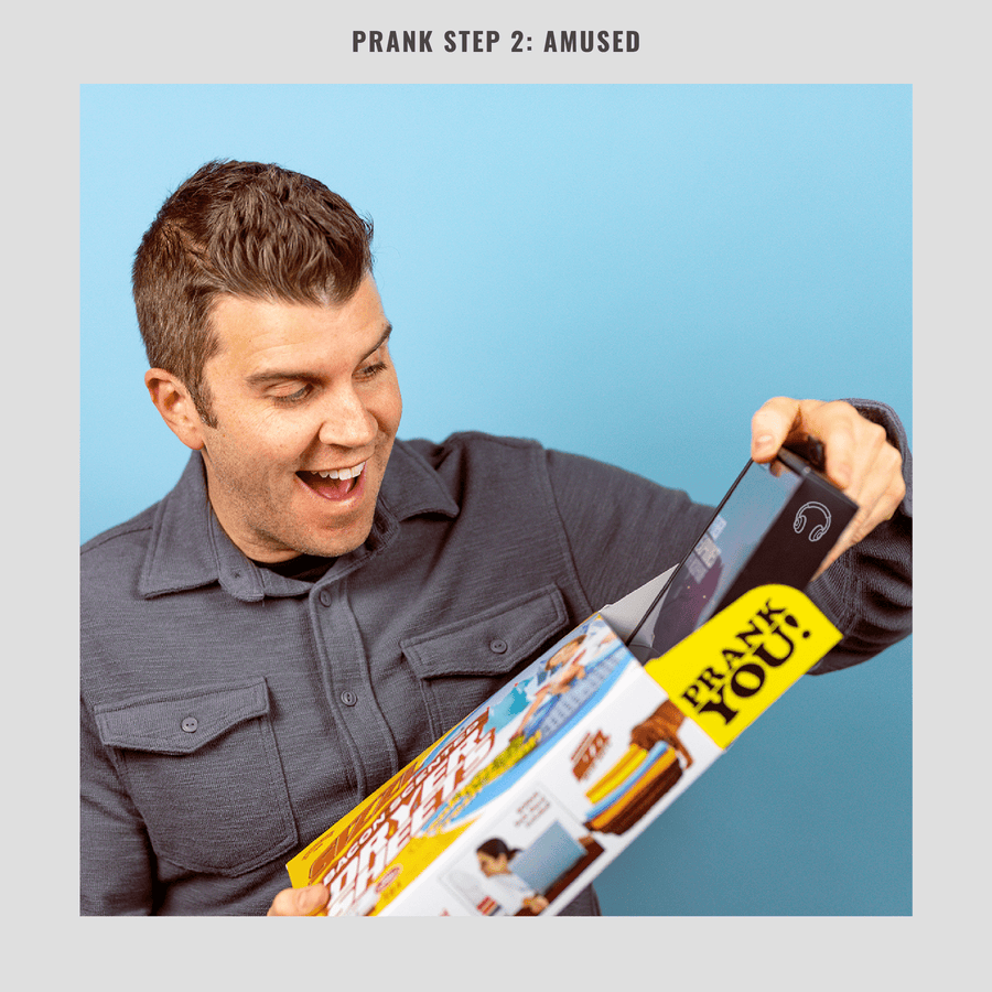 Man unboxing a gift from a Prank-o joke box